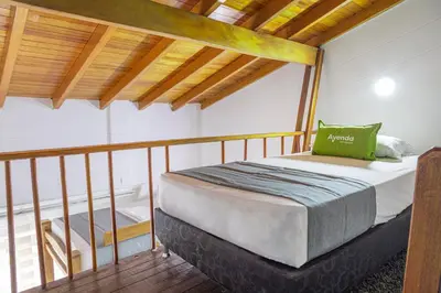 a bed in a room with a wooden ceiling at Hotel Boutique Laureles Home - Ayenda 1258 in Medellín