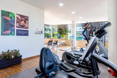 a fitness room with a gym with a treadmill at GHL Hotel Portón Medellín in Medellín