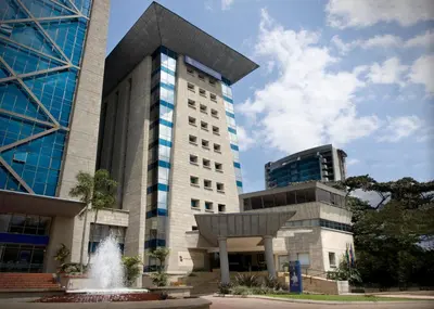 a building with a fountain in front of it at GHL Hotel Portón Medellín in Medellín