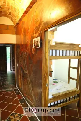 a room with a mural on the wall at El Quijote Apartahotel in Jericó