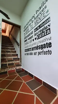 a room with a wall with words on the wall at El Quijote Apartahotel in Jericó