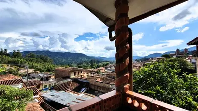 a view of a city from a balcony at El Quijote Apartahotel in Jericó