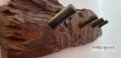 a close up of a wooden object with two knobs at El Quijote Apartahotel in Jericó