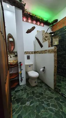 a bathroom with a toilet in a room at El Quijote Apartahotel in Jericó