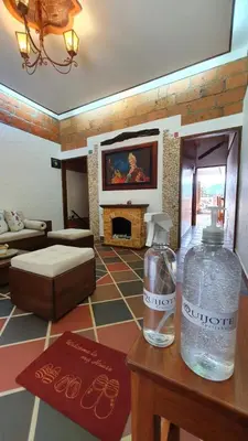 a living room with two bottles of water on a table at El Quijote Apartahotel in Jericó