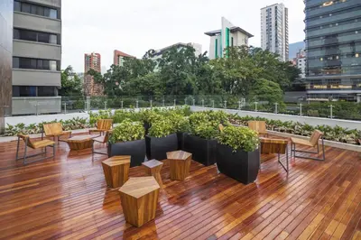 a rooftop patio with tables and chairs on a building at City Express Plus by Marriott Medellín Colombia in Medellín