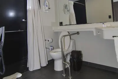 a bathroom with a toilet and a sink and a shower at City Express Plus by Marriott Medellín Colombia in Medellín