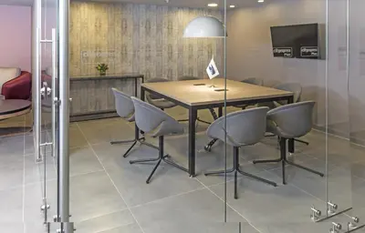 a conference room with a wooden table and chairs at City Express Plus by Marriott Medellín Colombia in Medellín