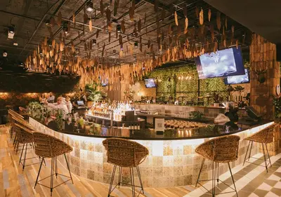 a bar in a restaurant with people sitting at it at InterContinental Medellin - Movich by IHG in Medellín
