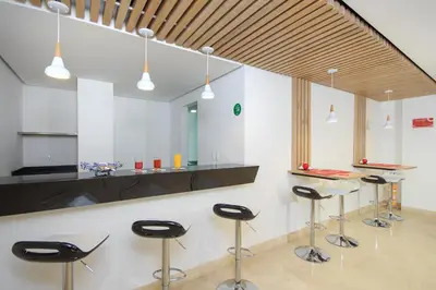a bar with black stools in a kitchen at Obo Hotel in Medellín