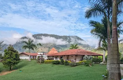 a house with palm trees and a mountain in the background at Patio Bonito in Jardin