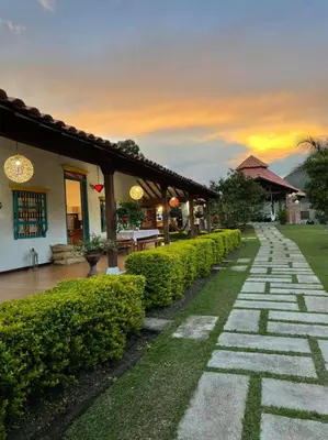 a stone walkway in front of a building with bushes at Patio Bonito in Jardin
