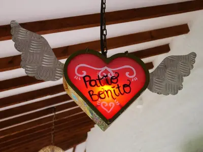 a heart shaped sign hanging from a ceiling at Patio Bonito in Jardin