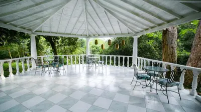 a pavilion with chairs and tables on a patio at Portón de Occidente by Bernalo Hotels in San Jerónimo