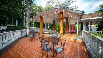 a patio with tables and chairs on a brick floor at Portón de Occidente by Bernalo Hotels in San Jerónimo