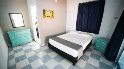 a bedroom with a bed and two blue cabinets at Portón de Occidente by Bernalo Hotels in San Jerónimo