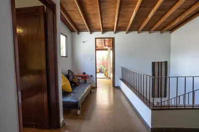 a living room with a couch and a staircase at Oasis en el corazón de Medellin, Laureles in Medellín