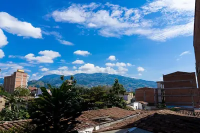 a view of the mountains from a city at Oasis en el corazón de Medellin, Laureles in Medellín
