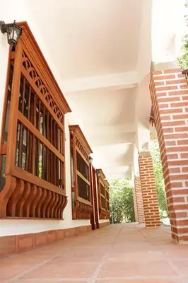 an empty hallway of a building with windows at Finca Hotel Guali Santafe in Santa Fe de Antioquia