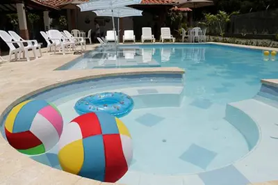 a swimming pool with a volley ball and a beach ball at Finca Hotel Guali Santafe in Santa Fe de Antioquia