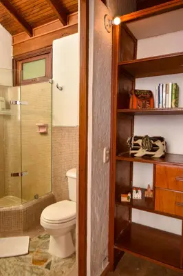 a bathroom with a toilet and a glass shower at La Campana Hotel Boutique in Medellín