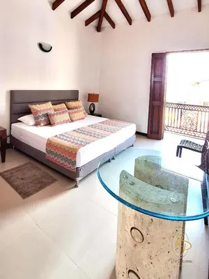 a bedroom with a bed and a glass table at Hotel Rio Piedras in Jericó