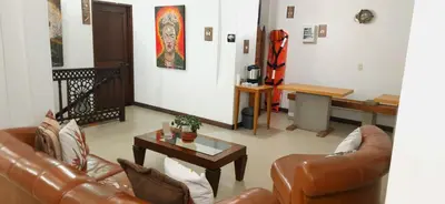 a living room with two leather couches and a table at Hotel Rio Piedras in Jericó