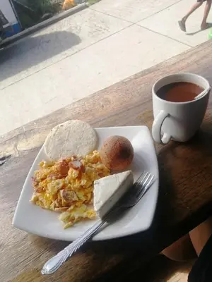 a plate of breakfast food and a cup of coffee at Hotel La Casona - San Luis in San Luis