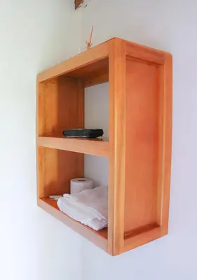a wooden book shelf hanging on a wall at Hotel La Casona - San Luis in San Luis