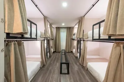 a room with four bunk beds with curtains at Medellín Vibes in Medellín