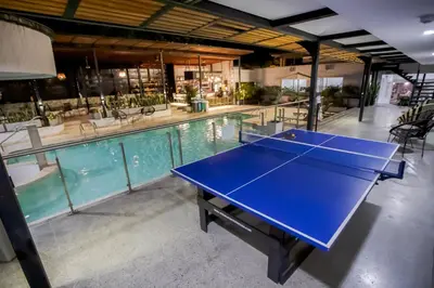 a ping pong table in front of a swimming pool at Medellín Vibes in Medellín