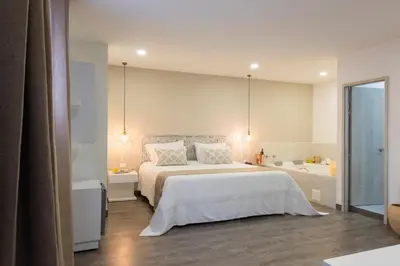 a bedroom with a white bed and a bath tub at Medellín Vibes in Medellín