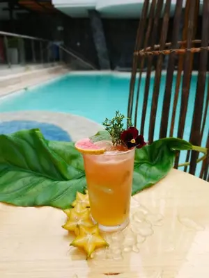a drink sitting on a table next to a pool at Medellín Vibes in Medellín