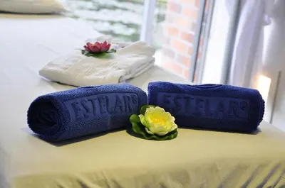 two towels sitting on top of a bed with flowers at Estelar Recinto Del Pensamiento Hotel Y Centro De Convenciones in Manizales