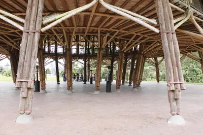a large wooden pavilion with people walking under it at Estelar Recinto Del Pensamiento Hotel Y Centro De Convenciones in Manizales