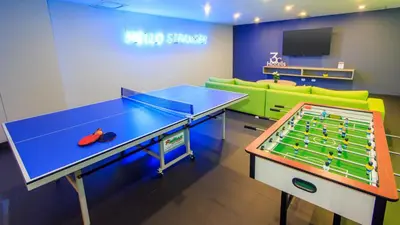 a room with a ping pong table and a game table at Pop Art Hotel Las Colinas Manizales in Manizales