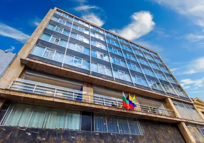 a tall building with two flags on a balcony at Pop Art Hotel Las Colinas Manizales in Manizales