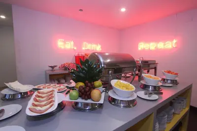 a buffet of food on a counter in a restaurant at Pop Art Hotel Las Colinas Manizales in Manizales