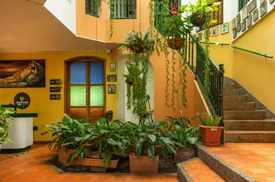 a building with stairs and plants in a courtyard at Ayenda Habana Vieja 1221 in Medellín