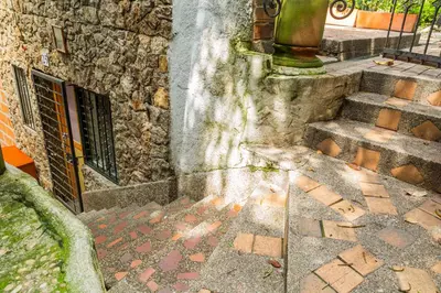 a stone building with stairs and a window at Ayenda Habana Vieja 1221 in Medellín