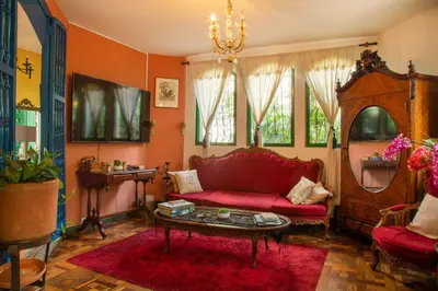 a living room with a red couch and a table at Ayenda Habana Vieja 1221 in Medellín