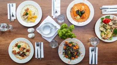 a wooden table with plates of food on it at Hotel Nutibara in Medellín
