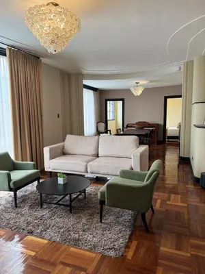 a living room with a couch and chairs and a table at Hotel Nutibara in Medellín