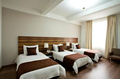 a hotel room with two beds and a window at Hotel Nutibara in Medellín