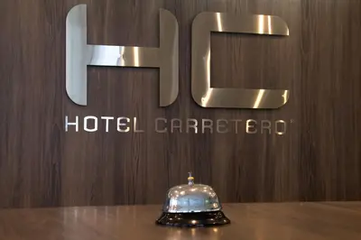 a hotel carror sitting on a table in front of a sign at Hotel Carretero in Manizales