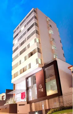 a tall building with a sign on the side of it at Hotel Estelar El Cable in Manizales