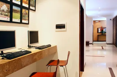 an office with a desk with a computer and a chair at Hotel Estelar El Cable in Manizales