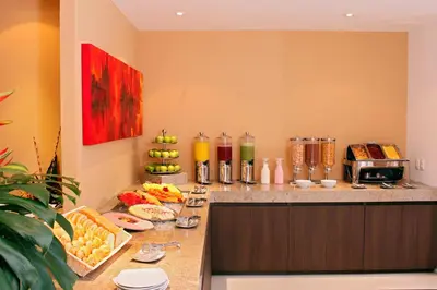 a kitchen with a counter with fruits and juice at Hotel Estelar El Cable in Manizales