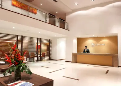 a man standing in the lobby of a hotel at Hotel Estelar El Cable in Manizales