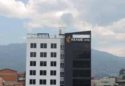 a white building with aania sign on top of it at Arame Hotel in Envigado